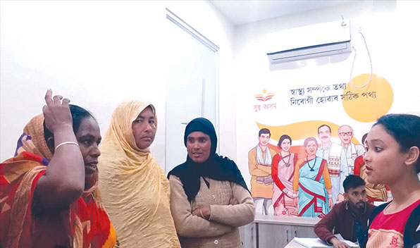 A nurse (right) counsels visitors who have walked in for screenings at the kiosk inside the Guwahati Medical College and Hospital